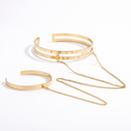 Delphine arm cuff and wrist cuff joined by a gold chain on white