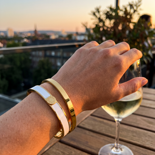 Aurel enamel bangle pair worn on the wrist at sunset