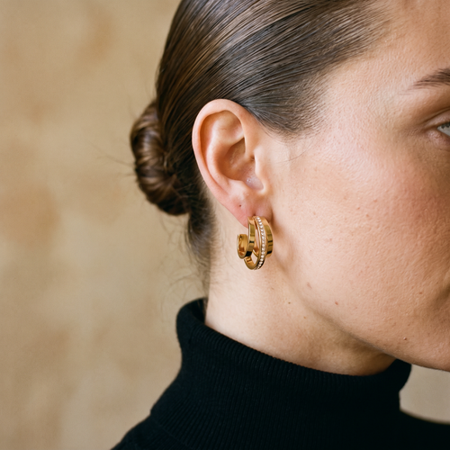 Nova triple crystal hoop earring worn with a black turtleneck