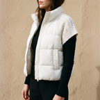 Nora white puffer vest showing the cable knit sleeves