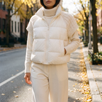Nora white knit sleeve puffer vest worn on an autumn street