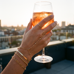 Ondine gold hand chain set worn holding a drink at golden hour