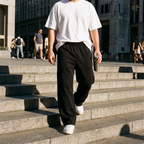 Reid black wide leg sweatpants worn on city steps