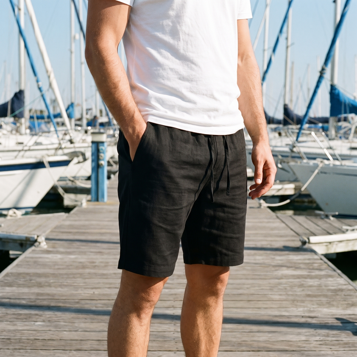 Tobin black linen shorts worn on a harbor dock