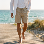 Tobin khaki linen shorts worn on a beach boardwalk at golden hour