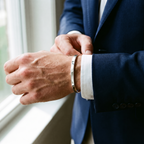Vance open cuff bangle, slim 3.5 mm white gold tone, worn with a navy blazer