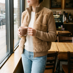 Vivienne khaki faux fur jacket worn in a cafe
