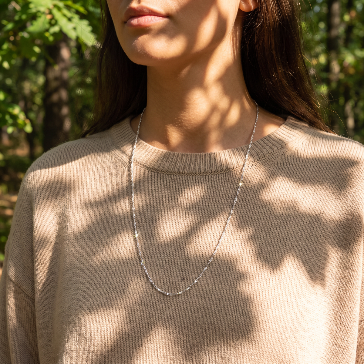 Lumera chain necklace in dappled sunlight