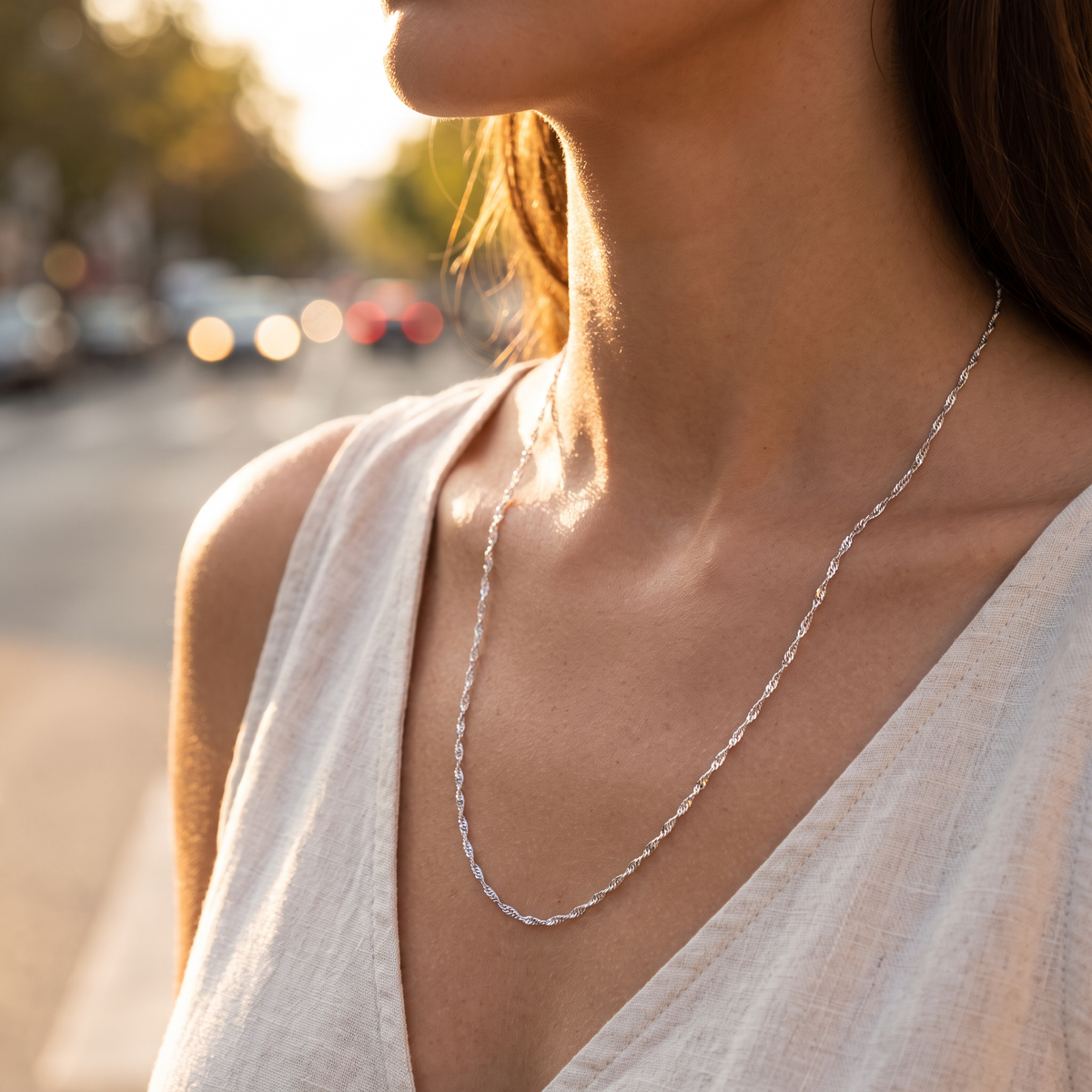 Lumera chain necklace worn in golden hour light