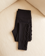 Vesper leggings folded flat on cream linen