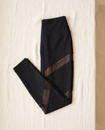 Astrid leggings folded flat on cream linen