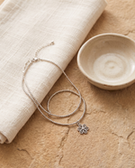 Fleur body chain styled on a stone surface