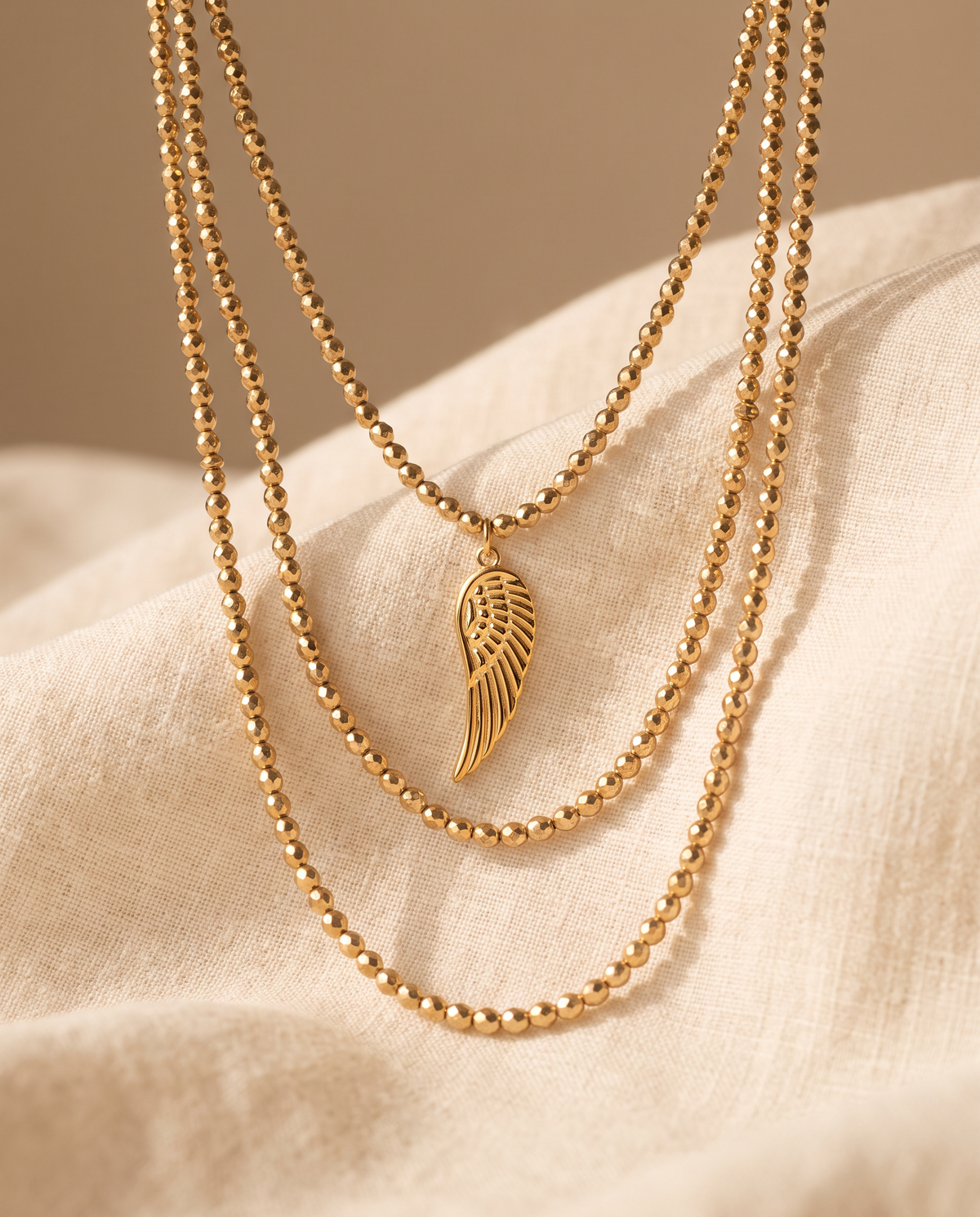 Seraph body chain arranged on cream linen