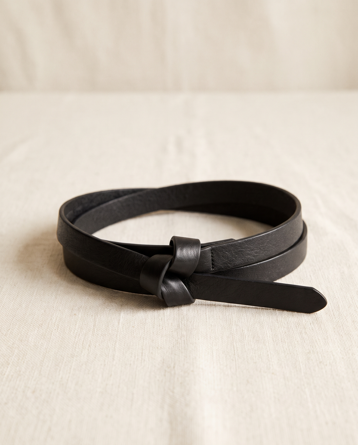 Noor belt knotted and coiled on cream linen