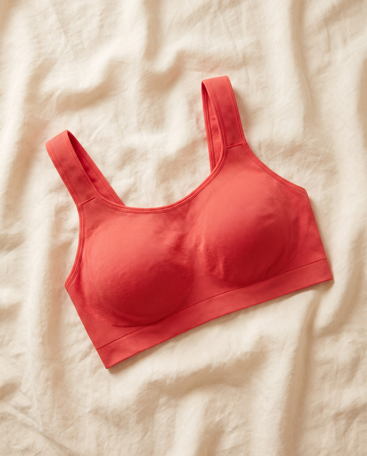 Rya sports bra laid flat on cream linen