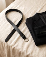 Noor belt laid beside a folded blazer