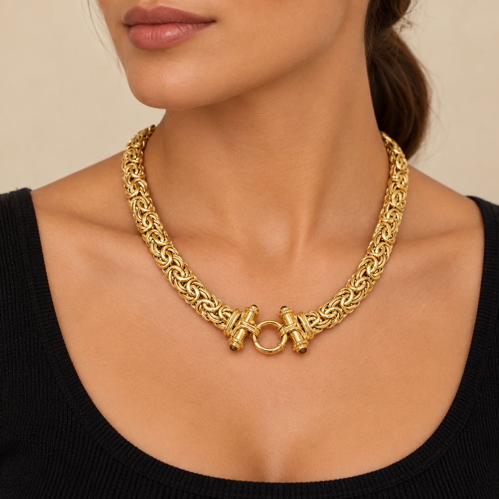 Gold Castor necklace worn with a black top
