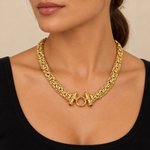 Gold Castor necklace worn with a black top