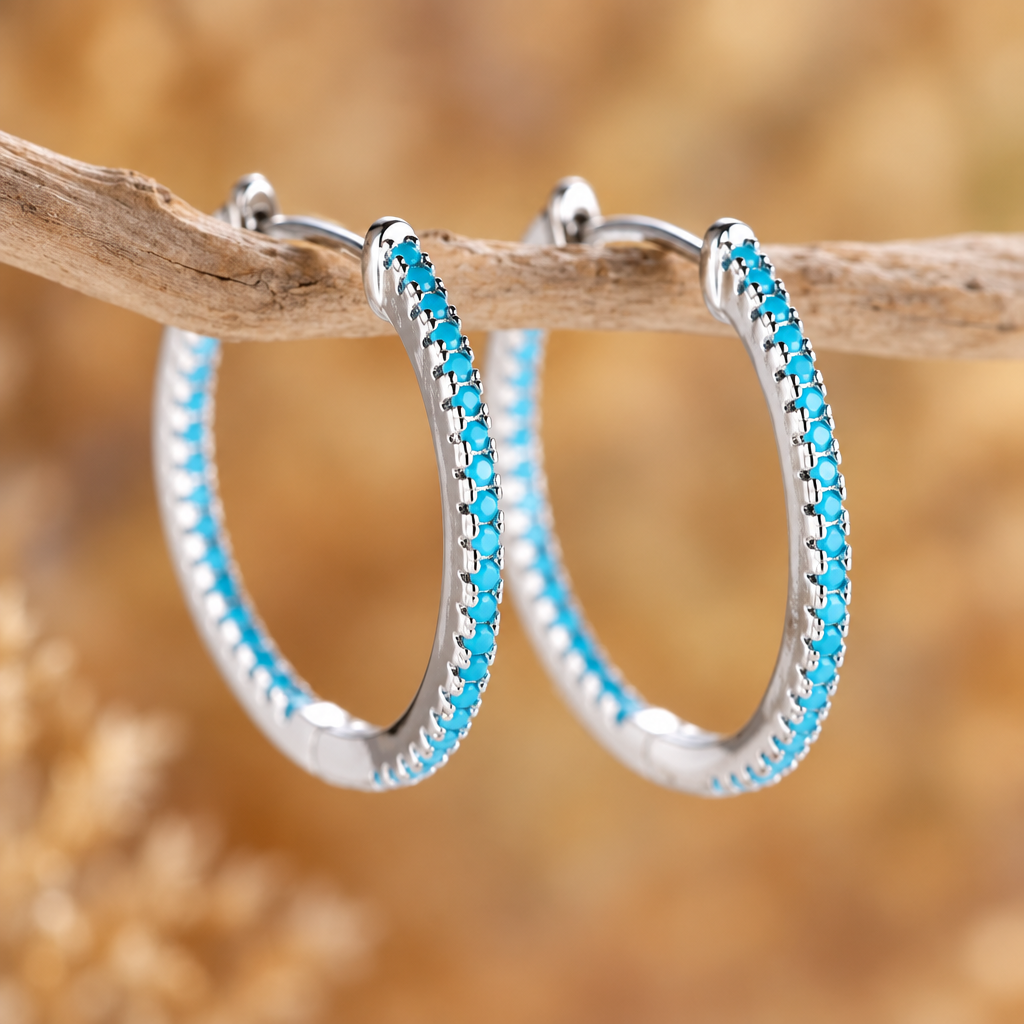 Marina turquoise hoops in silver hanging on driftwood