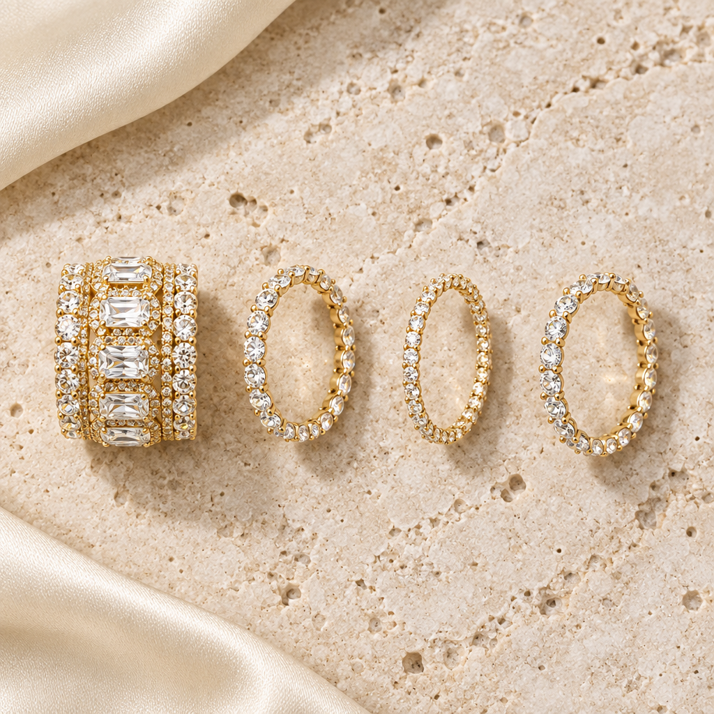 The four gold Esme rings laid out on stone