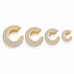 Halo pavé ear cuffs in gold on a white background