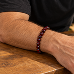 Ember bead bracelet worn on a man's wrist with a black tee