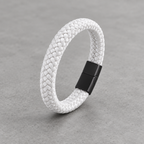 Kellan bracelet in white braid with matte black clasp on concrete