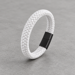 Kellan bracelet in white braid with matte black clasp on concrete