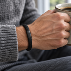 Black Kellan bracelet worn on a man's wrist with a knit sweater