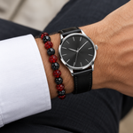 Ember bead bracelet stacked with a black leather watch