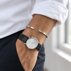 White gold tone Vance cuff worn with a watch