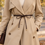 Brown Juliet belt tied over a beige trench coat