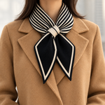 Elodie scarf crossed over a camel coat