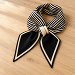 Elodie scarf folded on oak